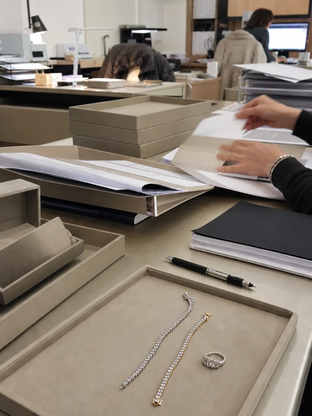 SIRO operational workflow desk with jewelry trays, documents, and team activity in 2020.